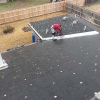 A Man Working On A Slap Roofing in Two Different Color