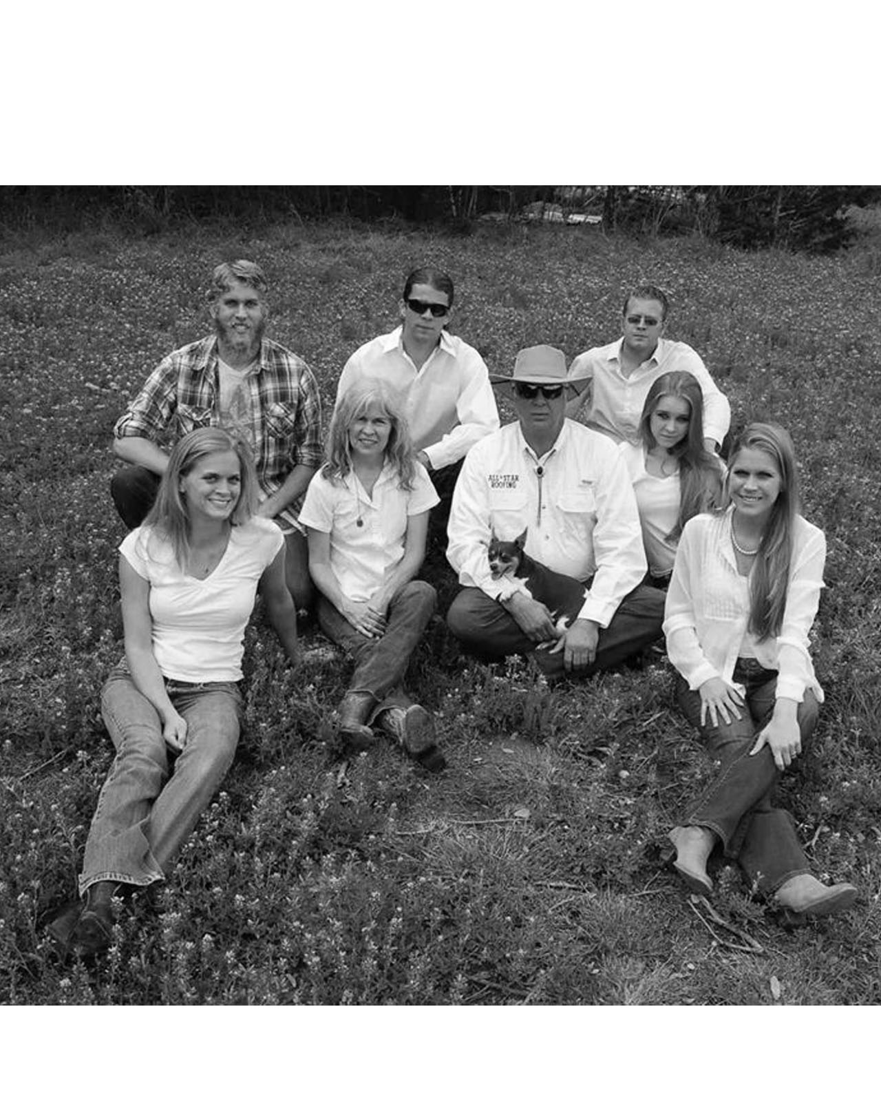 Black and white family group seated in meadow Black and white family group seated in meadow